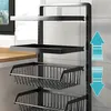 A close-up view of a black multi-tiered kitchen storage rack with wire baskets and flat shelves. Produktbild-Vorschau
