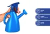 A hand holding a blue watering can with a spray nozzle. Produktbild-Vorschau