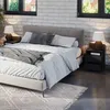 A bedroom scene with a bed, nightstand, and lamps. Náhled obrázku produktu