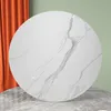 A round white marble-patterned tabletop is shown against a backdrop of orange curtains and a light green wall. Produktbild-Vorschau