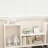 A white bookshelf with decorative items and books. Podgląd zdjęcia produktu