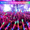 A crowd of people at a concert or festival, holding up glow sticks. Náhled obrázku produktu