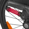 A close-up view of a red spring shock absorber on a bicycle wheel. Produktbild-Vorschau