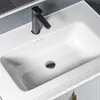 A close-up view of a white bathroom sink with a black faucet. Produktbild-Vorschau
