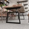 A dining table with metal legs in a room with chairs and shelves. Produktbild-Vorschau