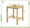 A wooden bar stool with a woven seat, shown from a slightly angled front view on a white background. Produktbild-Vorschau