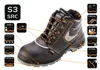 A black work boot with orange laces and accents, shown with various feature icons and text labels pointing to different parts of the boot. Náhľad obrázku produktu