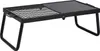 A black metal folding grill with legs, shown from a slightly elevated front-left angle against a white background. Voir les images du produit