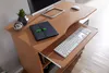 A close-up view of a wooden computer desk with a keyboard, mouse, and a small plant. Anteprima dell’immagine prodotto