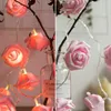 A split image showing two different arrangements of pink rose-shaped LED string lights. Produktbild-Vorschau