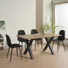 A dining set with a wooden table and four black chairs in a well-lit room. Produktbild-Vorschau