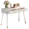 A white vanity table with gold accents and two drawers, one of which is open, displaying makeup and a vase of flowers. Podgląd zdjęcia produktu