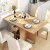 A dining table set up in a kitchen or dining area with chairs and place settings. Náhľad obrázku produktu