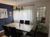 A dining room with a table, chairs, and a mirror on the wall. Produktbild-Vorschau