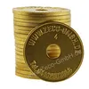 A stack of golden tokens with text and a hole in the center. Produktbild-Vorschau
