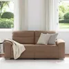 A sofa in a living room setting with windows and curtains in the background. Produktbild-Vorschau