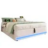 A bed with pillows and blankets, featuring integrated LED lighting and charging ports. Produktbild-Vorschau