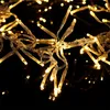 A close-up view of a string of warm white LED lights against a black background. Produktbild-Vorschau