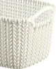 A close-up view of a white knit-style storage basket with a handle. Náhľad obrázku produktu