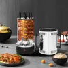 A vertical electric grill with skewers of meat and corn is displayed on a countertop, next to a stainless steel container and a bowl of rice. Other food items like crabs and cake are also visible. Podgląd zdjęcia produktu