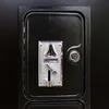 A close-up of a coin slot on a black machine. Produktbild-Vorschau