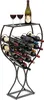 A black metal wine rack filled with wine bottles and two glasses of red wine on top. Produktbild-Vorschau