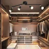 A well-organized walk-in closet with clothing and accessories displayed. Produktbild-Vorschau
