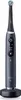 A dark gray electric toothbrush with a blue brush head sits on its charging base against a white background. Produktbild-Vorschau