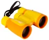 A pair of yellow and orange binoculars with a black strap against a white background. Produktbild-Vorschau