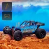 A blue remote-controlled car is shown on a dirt terrain with a cloudy blue sky in the background. There are two icons in the top left corner, one depicting a shock absorber and the other a car. Anteprima dell’immagine prodotto