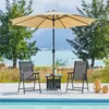 Two chairs and a table are set up on a deck by a pool, with trees and water in the background. Produktbild-Vorschau