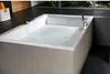 A modern bathroom with a large bathtub filled with bubbly water. Produktbild-Vorschau