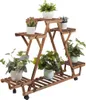 A wooden plant stand with multiple tiers holding various potted plants. Produktbild-Vorschau