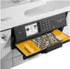 A close-up shot of a Brother printer with a document partially ejected from the paper tray. Voir les images du produit