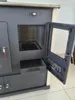 A close-up view of a beige and gray wood-burning stove with its oven door open. Voir les images du produit