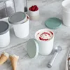 Ice cream containers and cones on a marble countertop. Produktbild-Vorschau