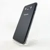 A black Samsung Galaxy J7 2016 smartphone is displayed on a clear stand against a white background. Náhľad obrázku produktu