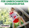 A young girl is happily swinging on a red swing set in a garden setting. Produktbild-Vorschau