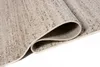 A close-up, rolled-up view of a beige and cream rug with a textured, speckled pattern. Náhľad obrázku produktu