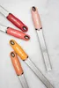 Several colorful Microplane graters are arranged on a light gray surface. Anteprima dell’immagine prodotto