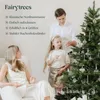 A family is decorating a Christmas tree in a cozy indoor setting. Produktbild-Vorschau