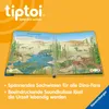 An open book with illustrations of dinosaurs and text, set against an orange background with the brand logo. Podgląd zdjęcia produktu