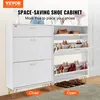 A white shoe cabinet with gold accents, featuring multiple shelves and drawers, is shown in a room setting with shoes displayed inside. Produktbild-Vorschau