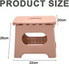 A pink folding stool with size measurements indicated. Produktbild-Vorschau