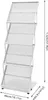 A white, multi-tiered magazine rack is shown against a white background with dimensions indicated by text and arrows. Náhled obrázku produktu
