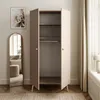 A two-door wardrobe with an open door, showing shelves and a hanging rail, in a room with a mirror and artwork. Produktbild-Vorschau
