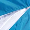 A close-up view of a partially opened zipper on a blue fabric item, revealing white filling material inside. Anteprima dell’immagine prodotto