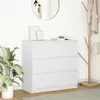 A white dresser with three drawers is shown in a room with a plant and a coat rack. Produktbild-Vorschau