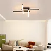 A modern living room with a sofa, coffee table, and a unique ceiling light. Produktbild-Vorschau