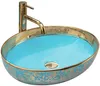 A close-up studio shot of a decorative vessel sink with a gold faucet. Produktbild-Vorschau